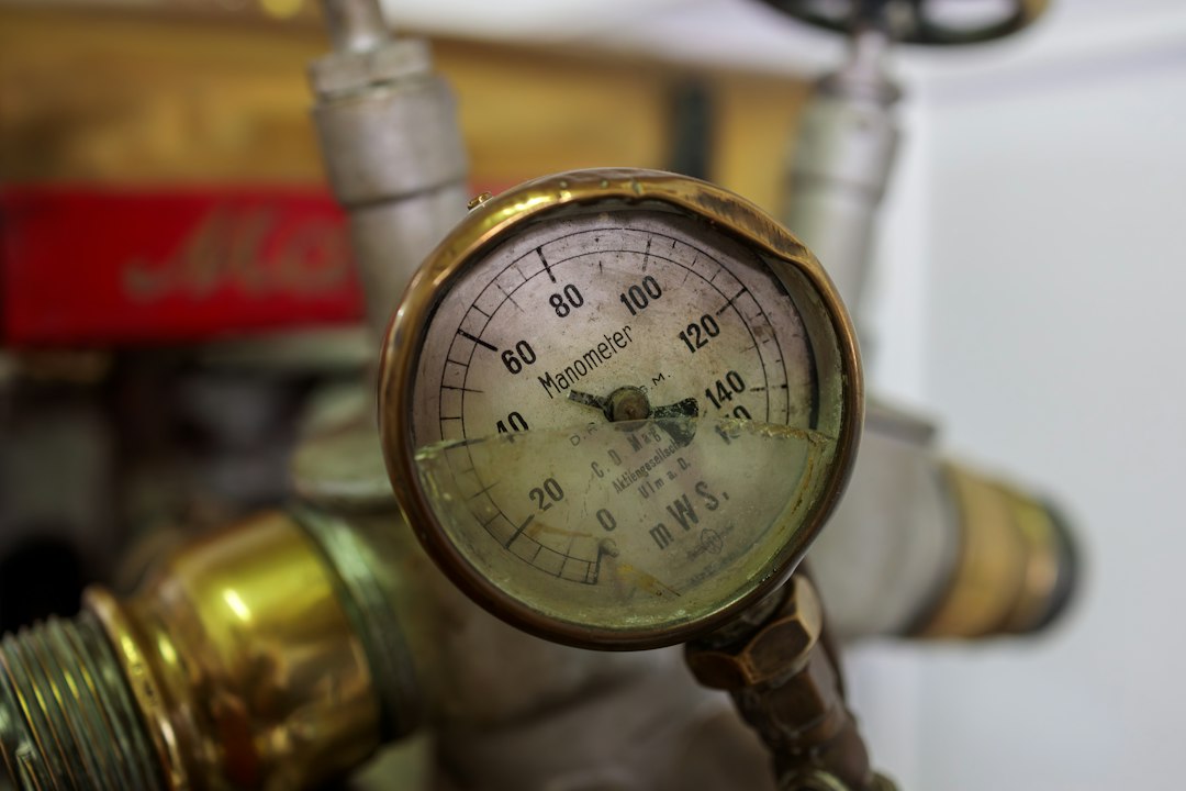 technician connecting manifold gauges to A/C service ports