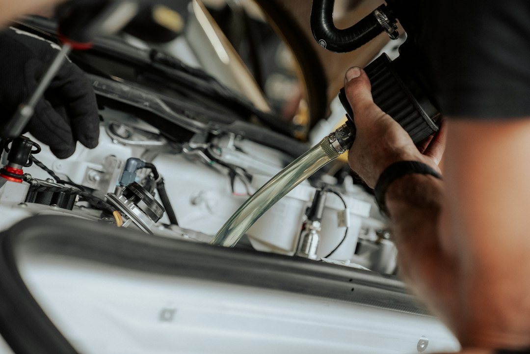 technician inspecting car AC condenser and lines